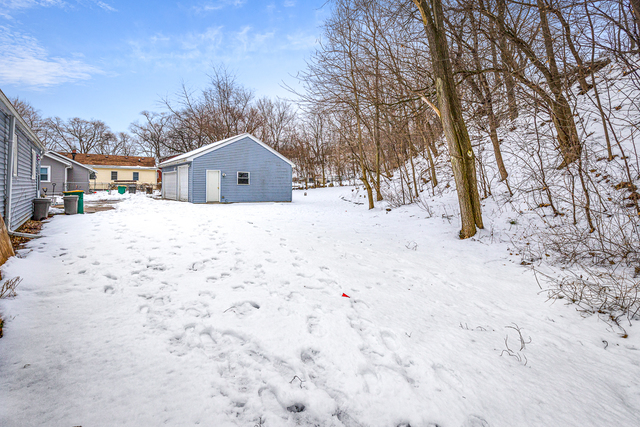 81-83 Eagle Point Road Fox Lake, IL 60020 - Photo 22 of 23 a front view of a house with a yard covered in snow
