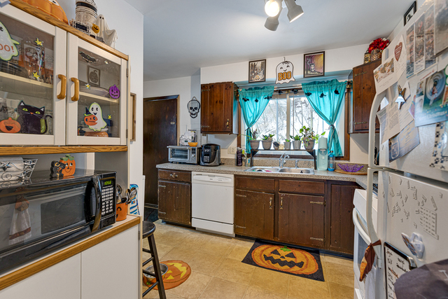 81-83 Eagle Point Road Fox Lake, IL 60020 - Photo 5 of 23 a kitchen with stainless steel appliances granite countertop a stove a sink and a refrigerator