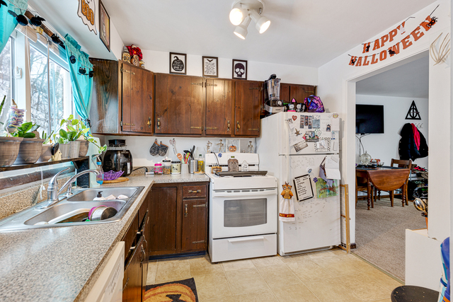 81-83 Eagle Point Road Fox Lake, IL 60020 - Photo 6 of 23 a kitchen with a stove a refrigerator and a sink