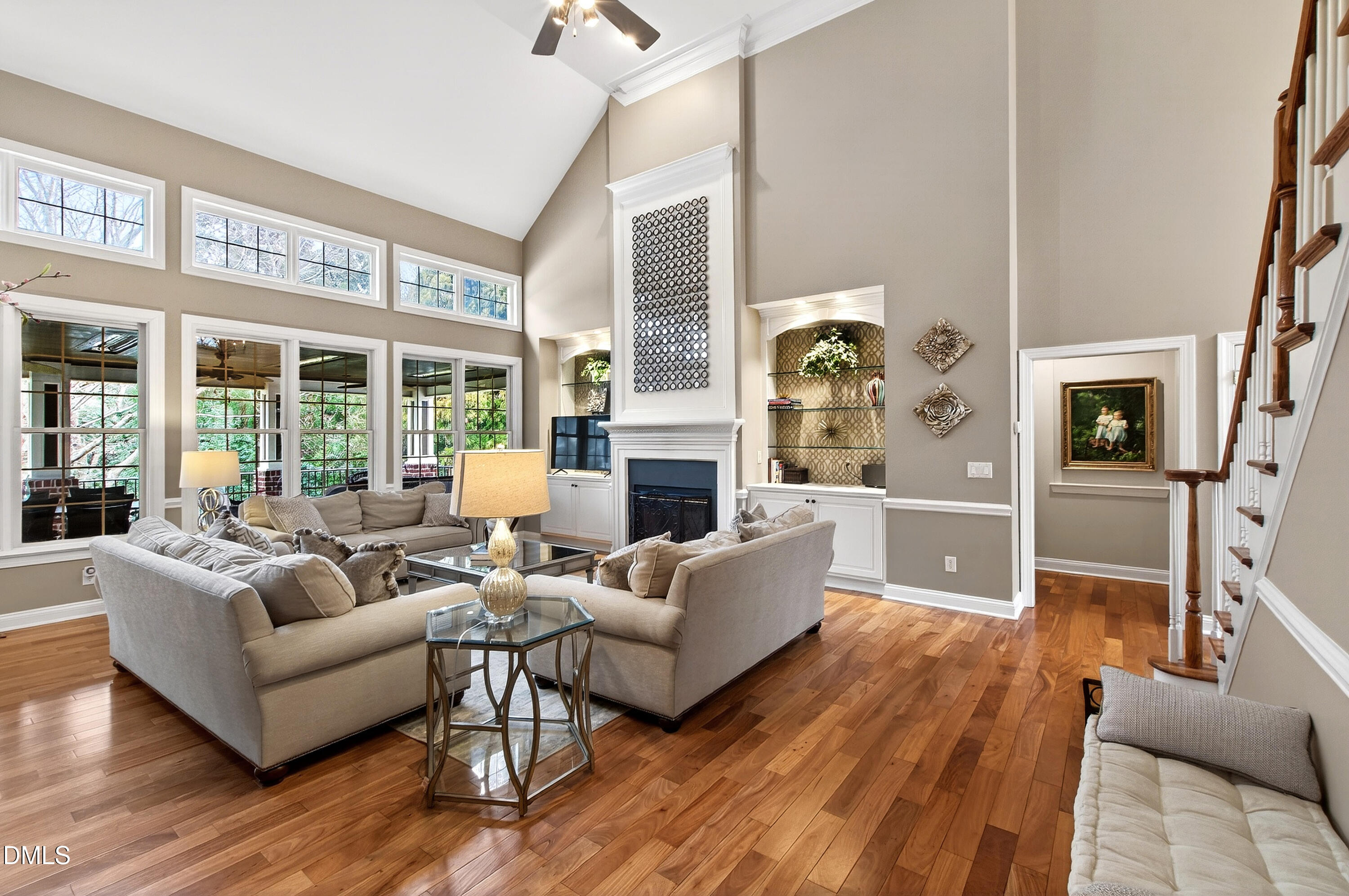 12325 Camberwell Court Raleigh, NC 27614 - Photo 16 of 76 a living room with fireplace furniture and a floor to ceiling window