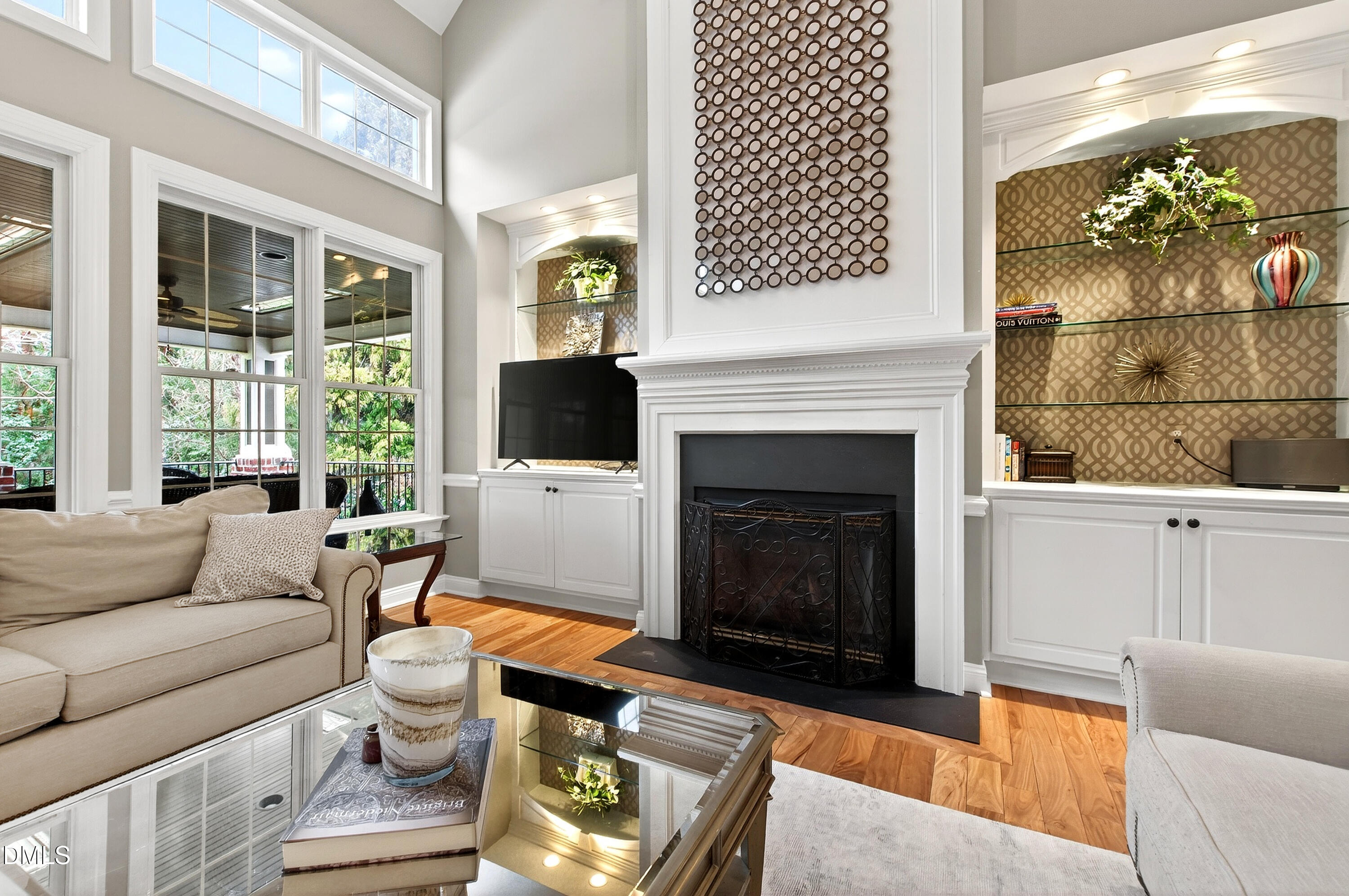 12325 Camberwell Court Raleigh, NC 27614 - Photo 17 of 76 a living room with furniture a flat screen tv and a fireplace