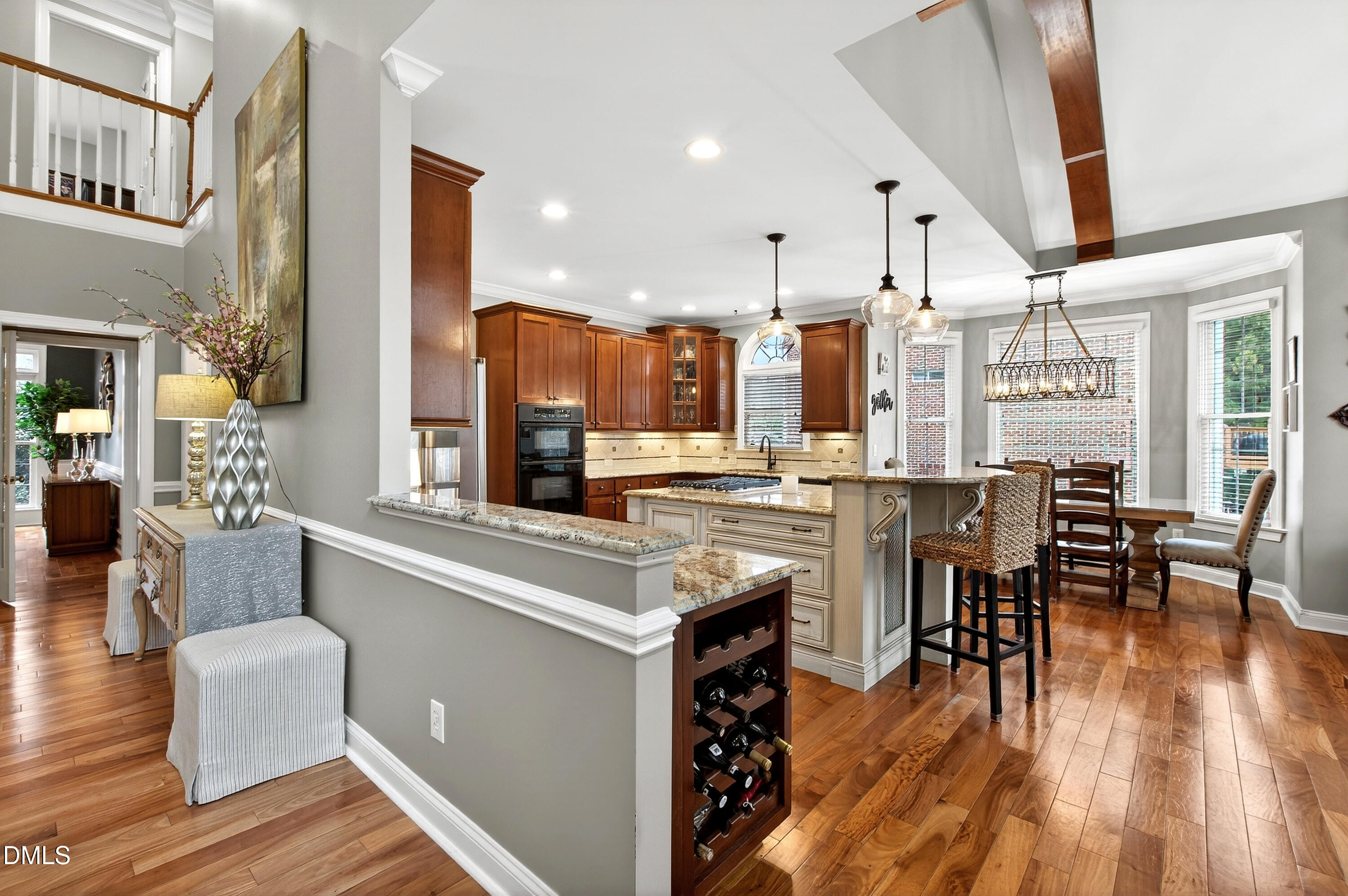 12325 Camberwell Court Raleigh, NC 27614 - Photo 18 of 76 a open kitchen with stainless steel appliances kitchen island granite countertop a table chairs and a stove