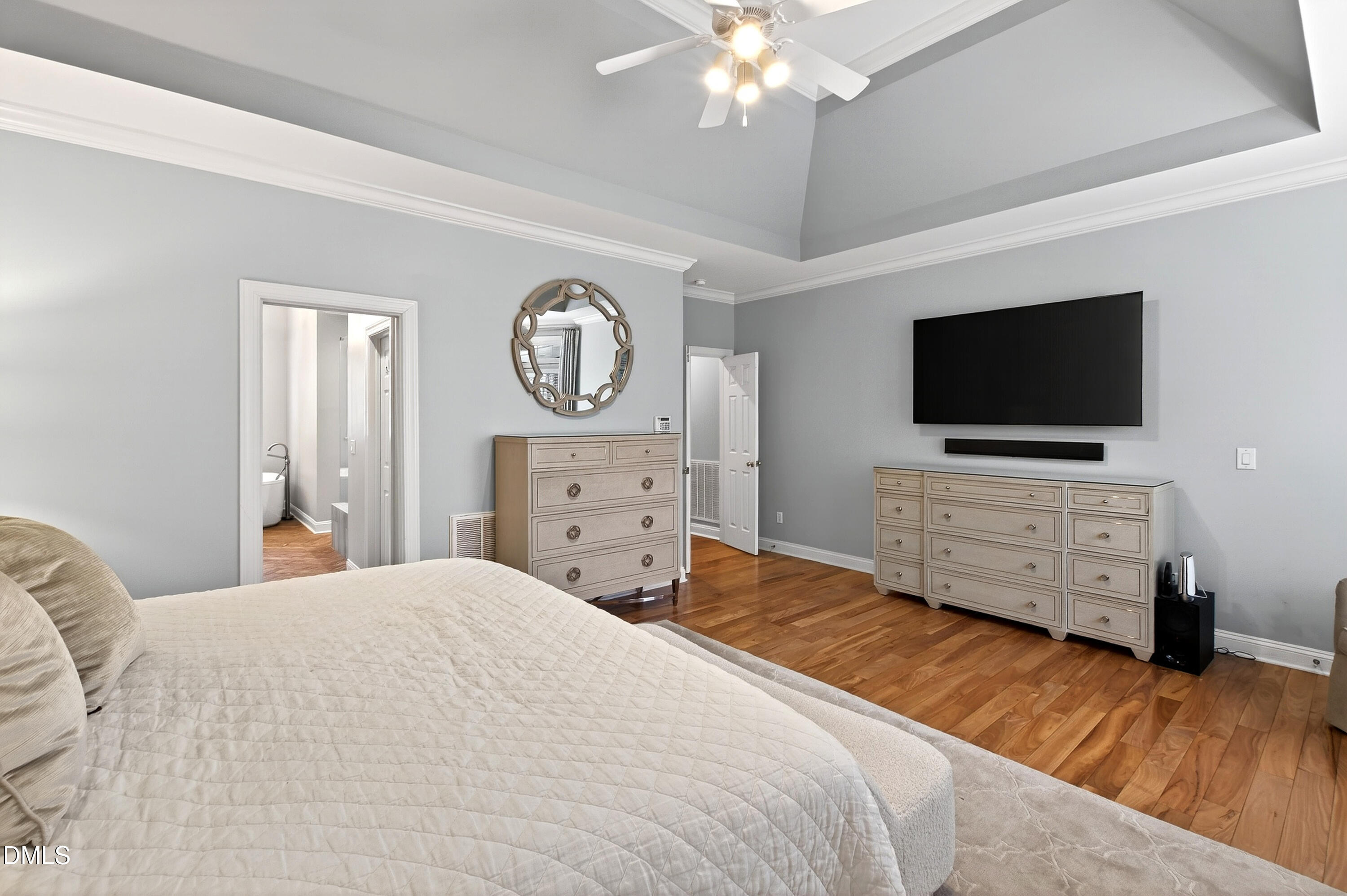 12325 Camberwell Court Raleigh, NC 27614 - Photo 32 of 76 a bedroom with a bed and a flat tv screen on dresser