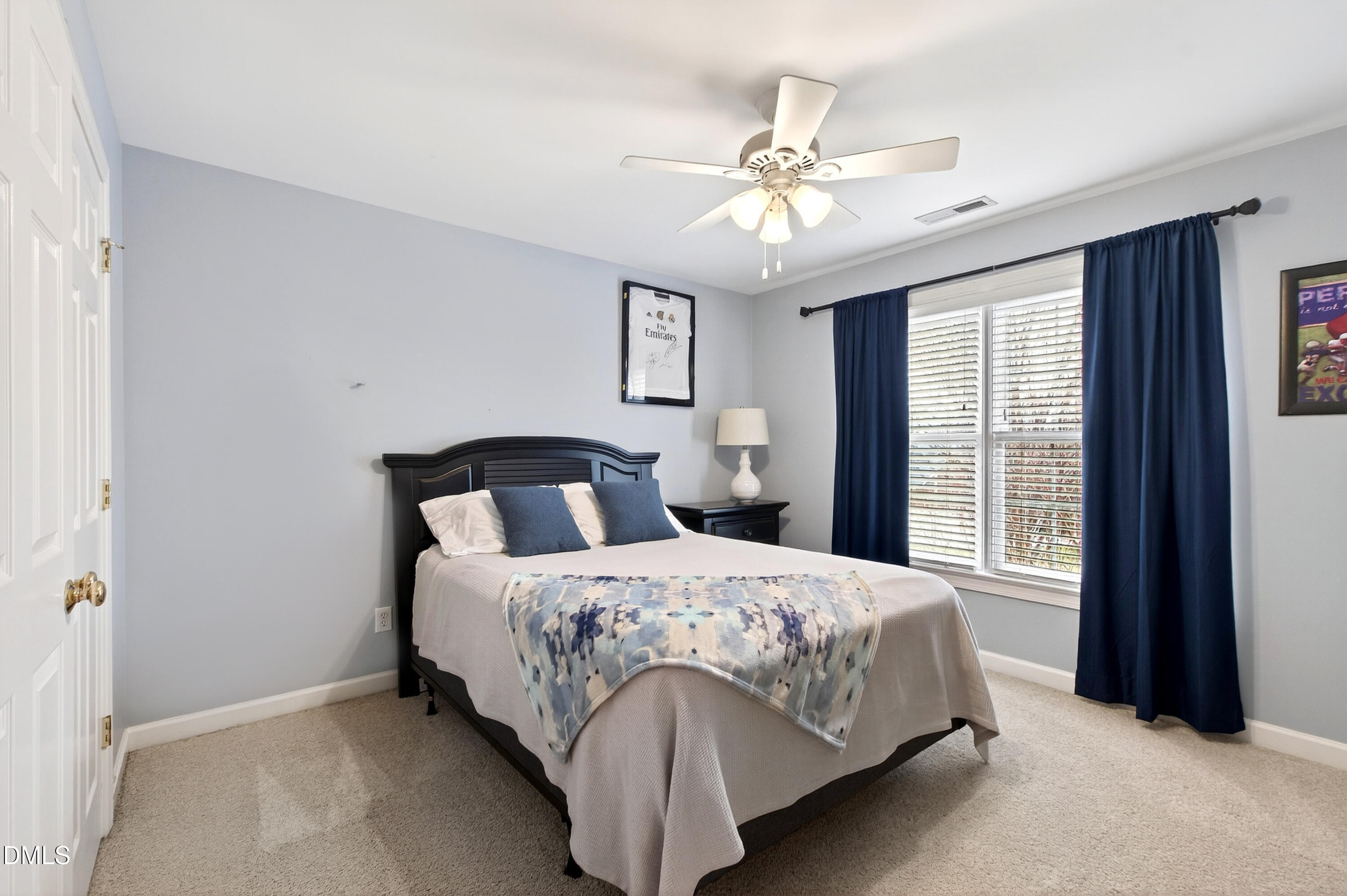 12325 Camberwell Court Raleigh, NC 27614 - Photo 44 of 76 a bedroom with a bed and a chandelier