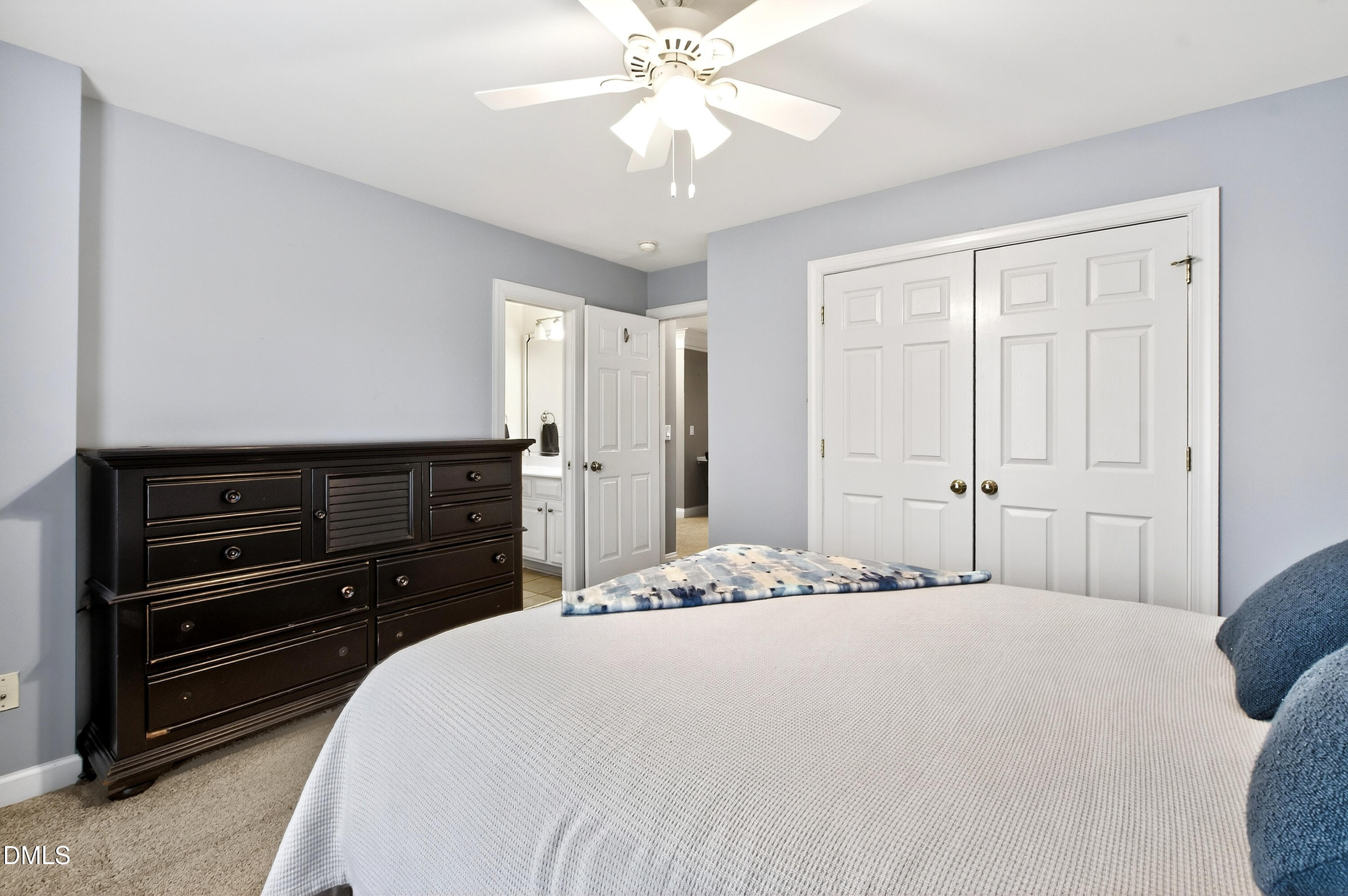 12325 Camberwell Court Raleigh, NC 27614 - Photo 45 of 76 a bedroom with a bed and a ceiling fan
