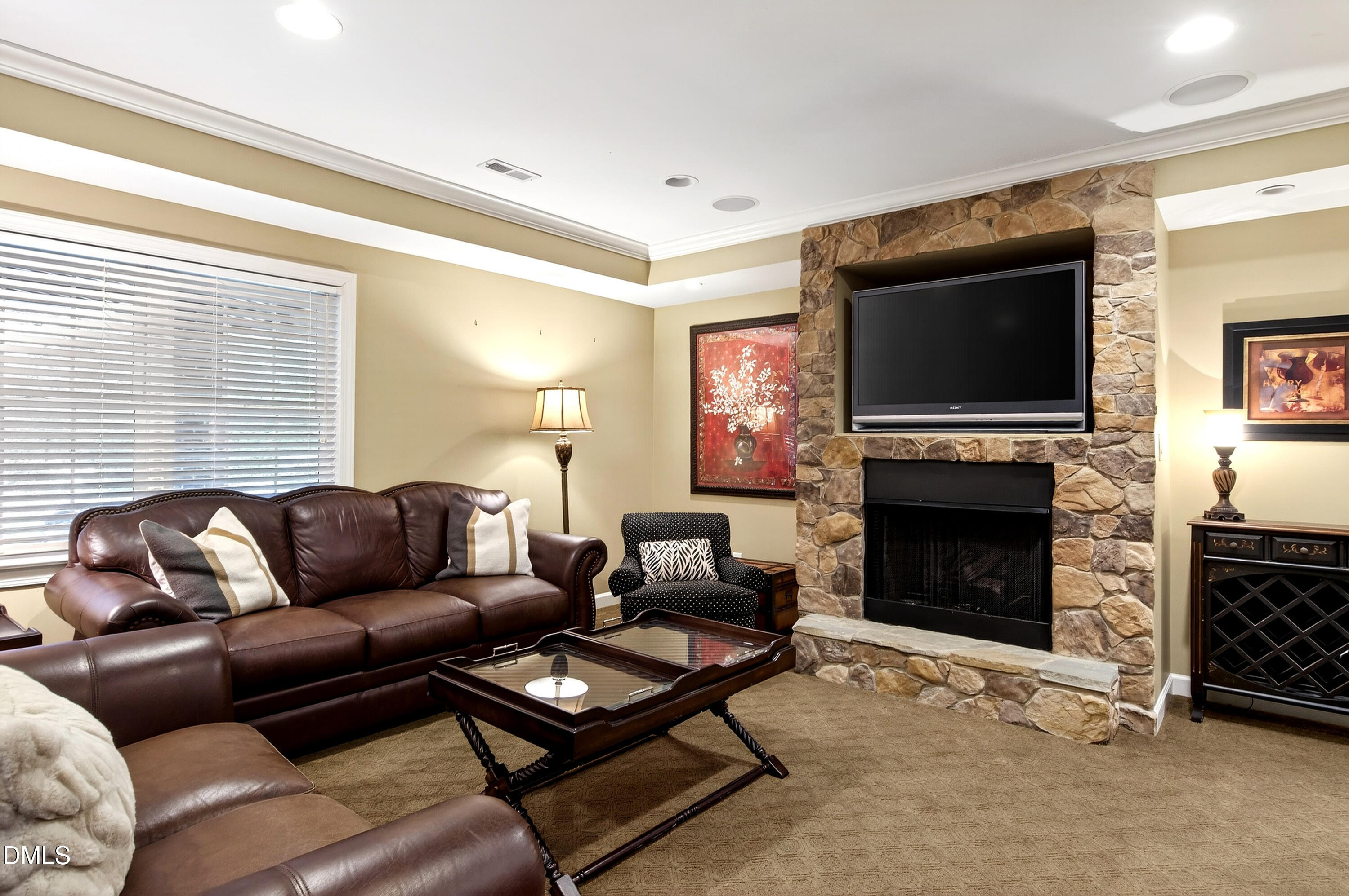 12325 Camberwell Court Raleigh, NC 27614 - Photo 55 of 76 a living room with furniture a flat screen tv and a fireplace