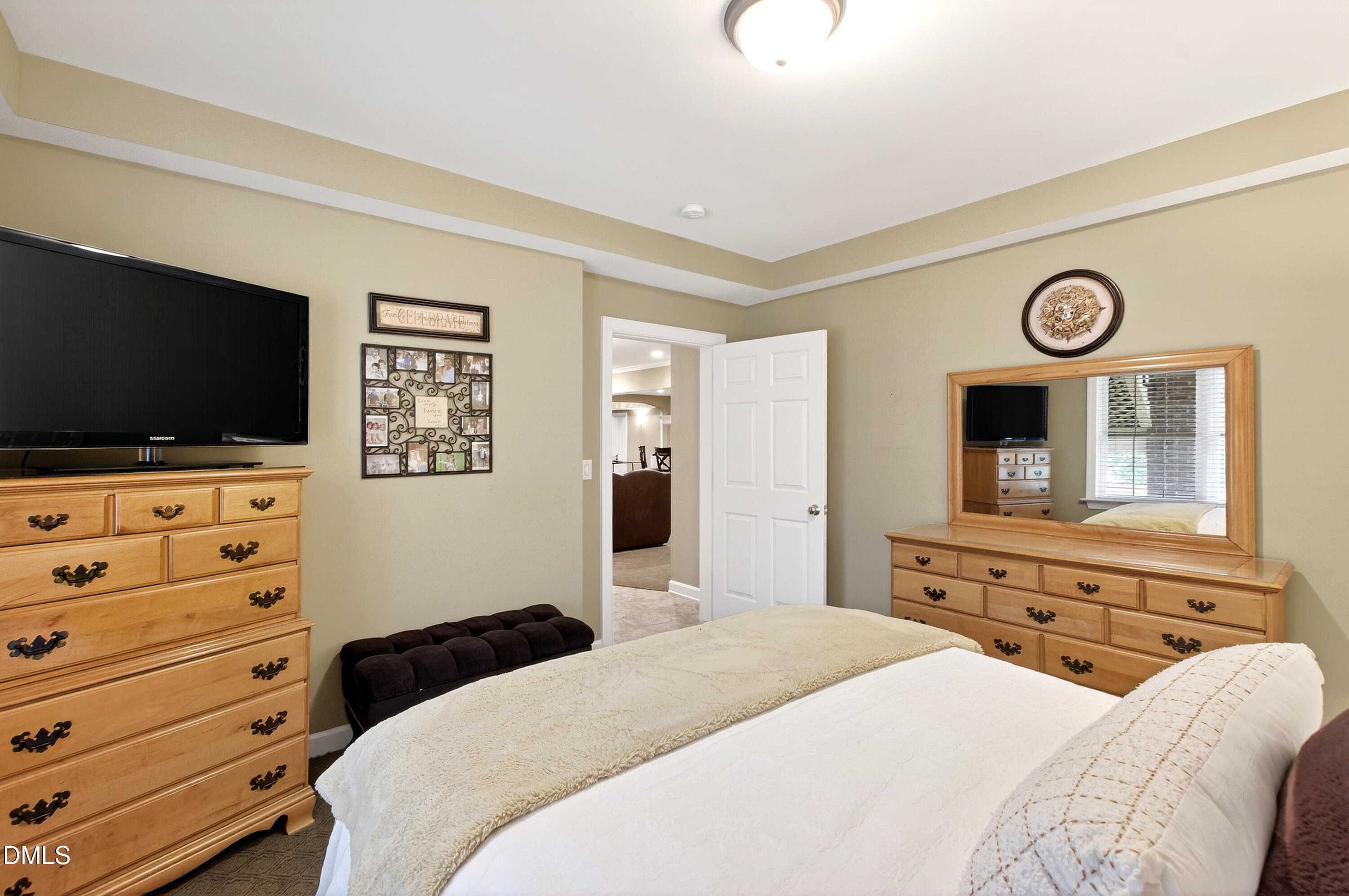 12325 Camberwell Court Raleigh, NC 27614 - Photo 60 of 76 a bedroom with a bed and a flat screen tv