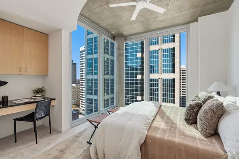 a bed sitting in a bedroom next to a window