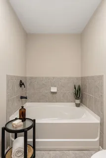 a bathroom with a bathtub and a sink