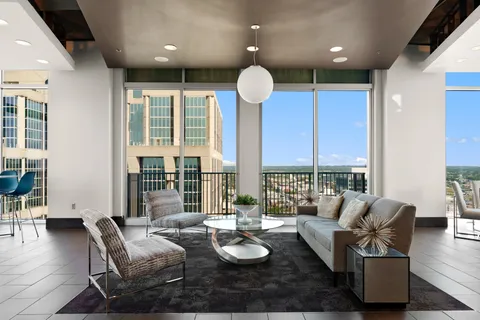 a kitchen with stainless steel appliances granite countertop a sink and a refrigerator