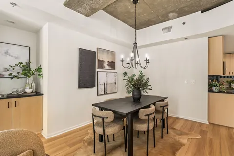 a view of a dining room with furniture and wooden floor