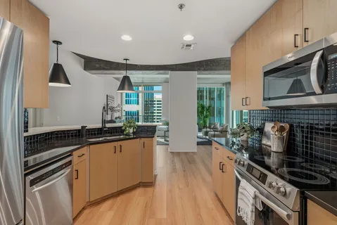a kitchen with stainless steel appliances granite countertop a stove and a sink