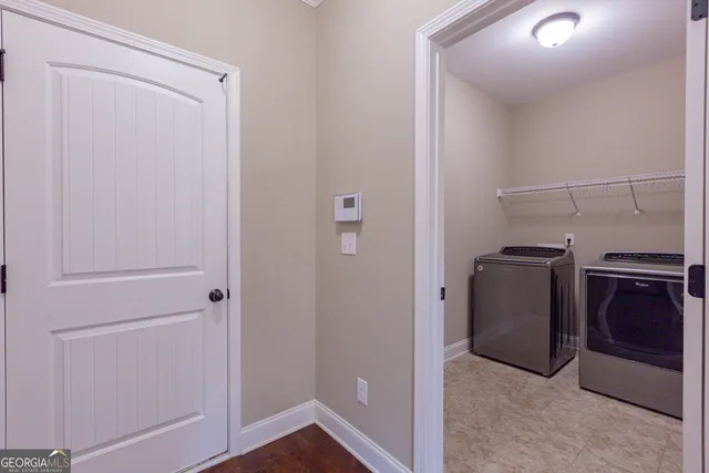 a view of staircase with lots of frames on wall and wooden floor