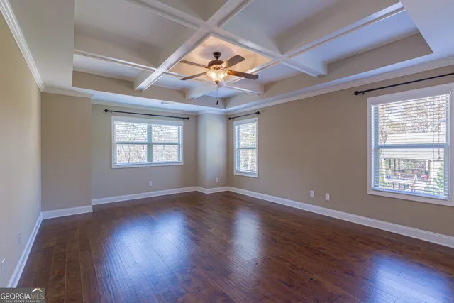 a bathroom with a granite countertop toilet a sink and a mirror