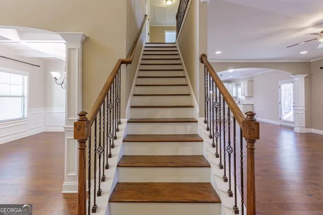 a front view of a house with a yard and mountain view