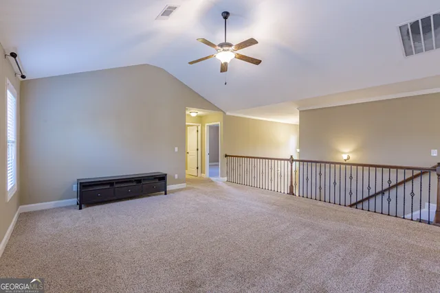 a very nice looking living room with a large window and dining table
