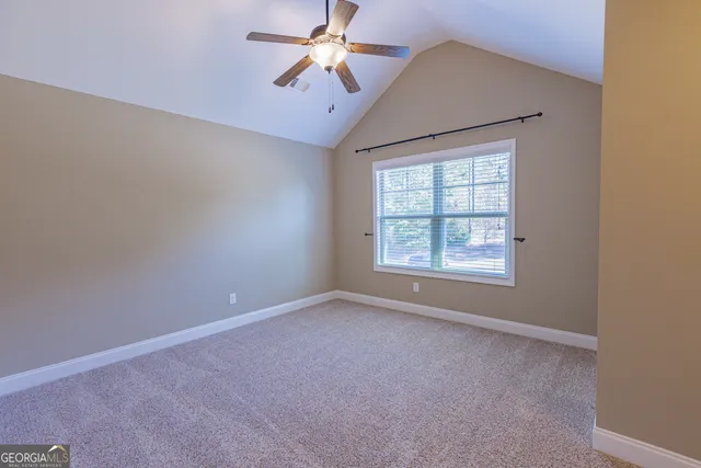 a view of a swimming pool and lounge chairs
