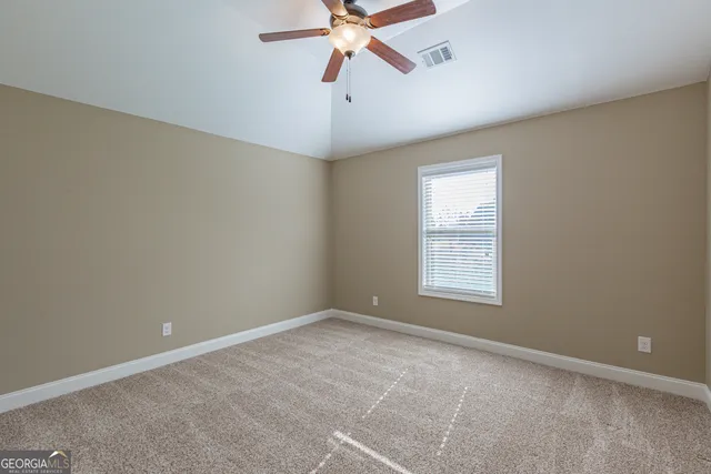 a view of a flower garden in front of a house
