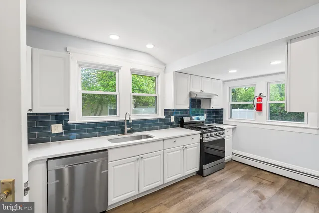 a kitchen with a sink stove and cabinets