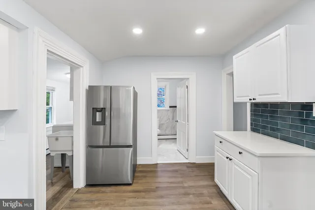 a kitchen with a refrigerator and a sink
