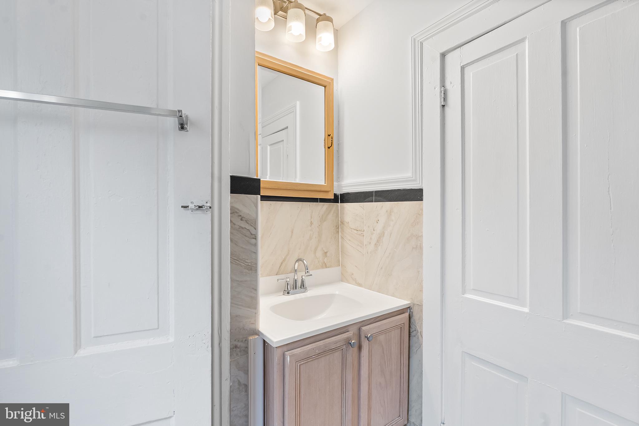 131 West Clinton Street Clayton, NJ 08312 - Photo 18 of 41 a bathroom with a sink and a mirror