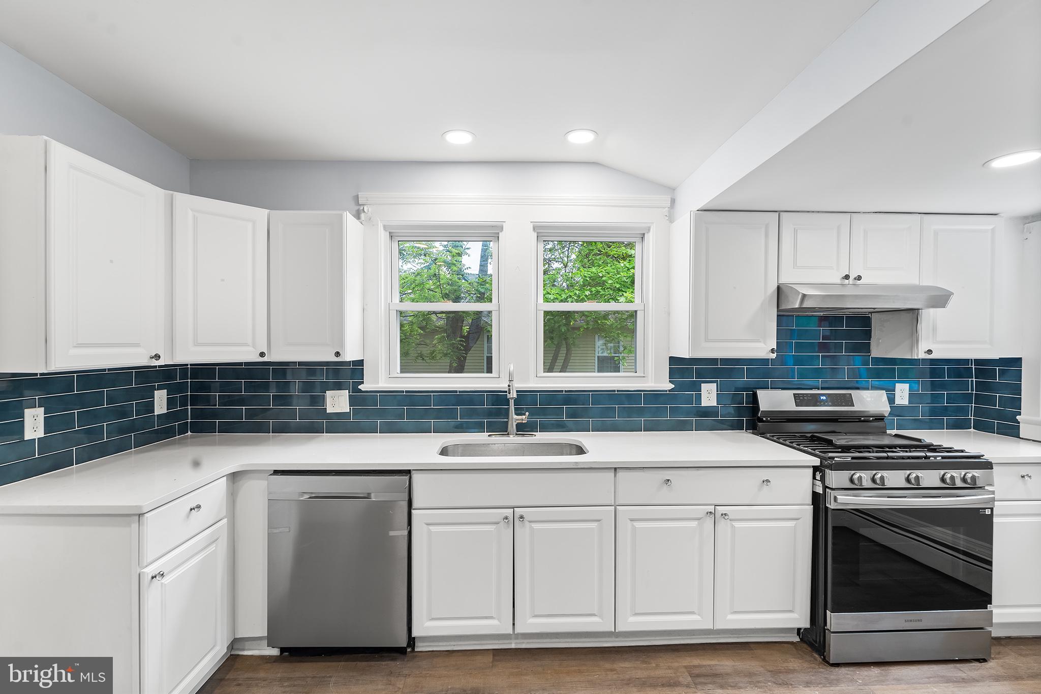 131 West Clinton Street Clayton, NJ 08312 - Photo 2 of 41 a kitchen with granite countertop a sink stainless steel appliances and white cabinets