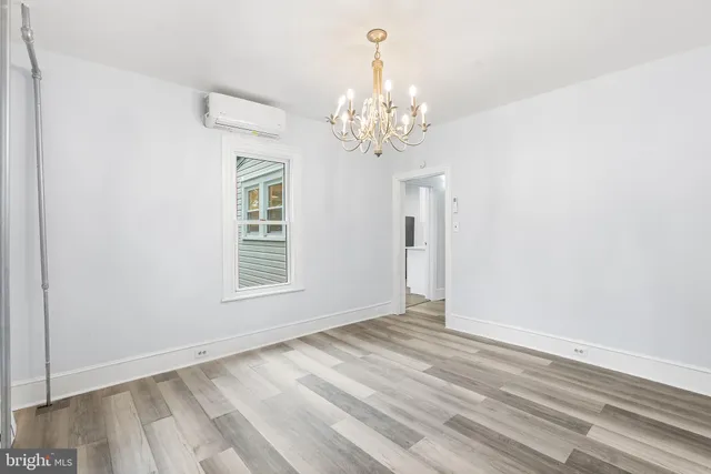 an empty room with windows and entrance