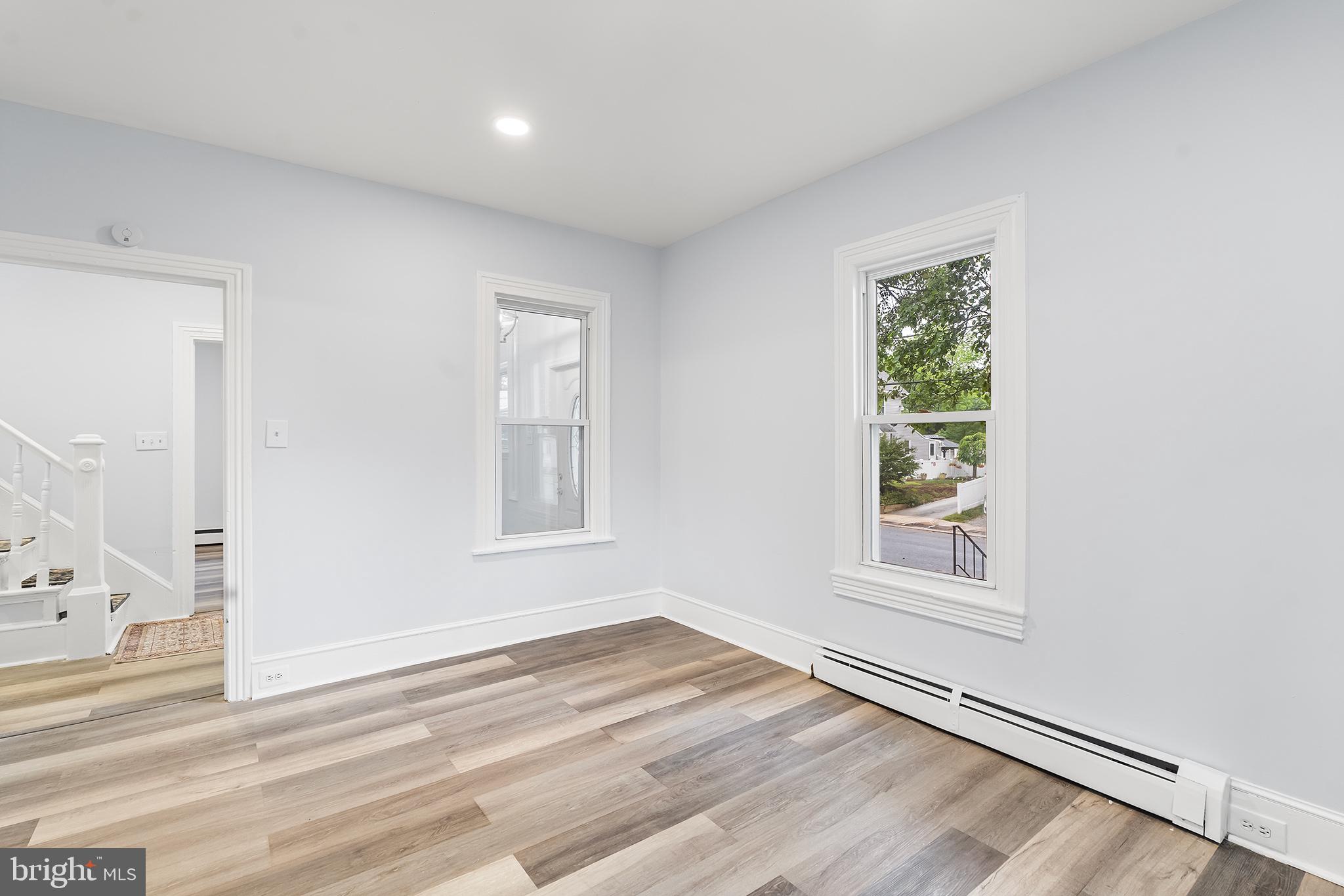 131 West Clinton Street Clayton, NJ 08312 - Photo 23 of 41 an empty room with wooden floor and windows