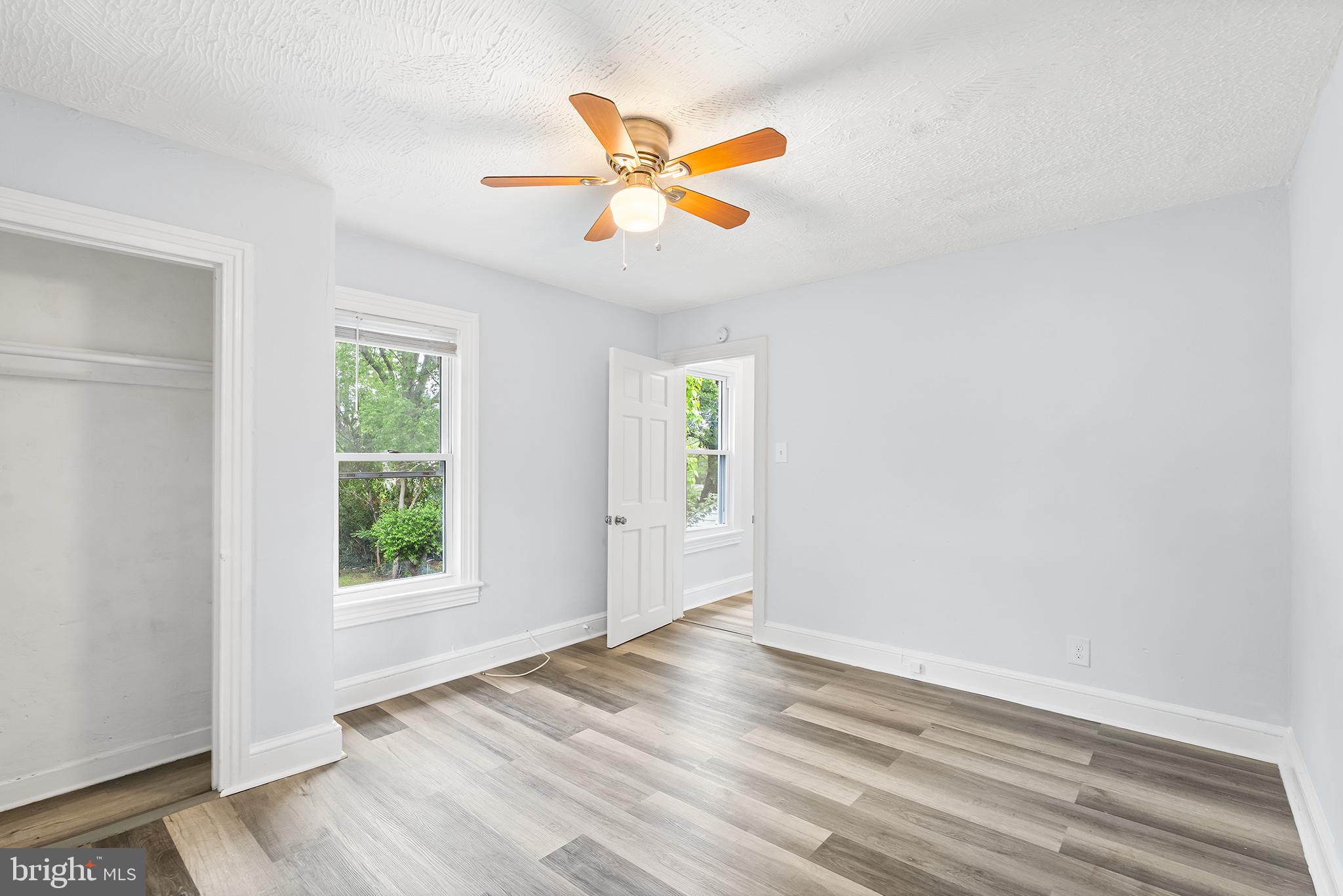 131 West Clinton Street Clayton, NJ 08312 - Photo 28 of 41 an empty room with wooden floor fan and windows