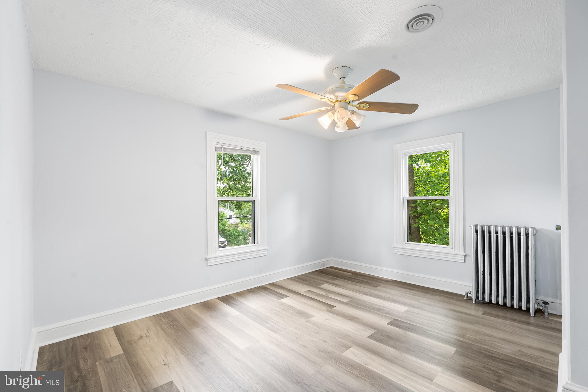131 West Clinton Street Clayton, NJ 08312 - Photo 29 of 41 an empty room with a window and a ceiling fan