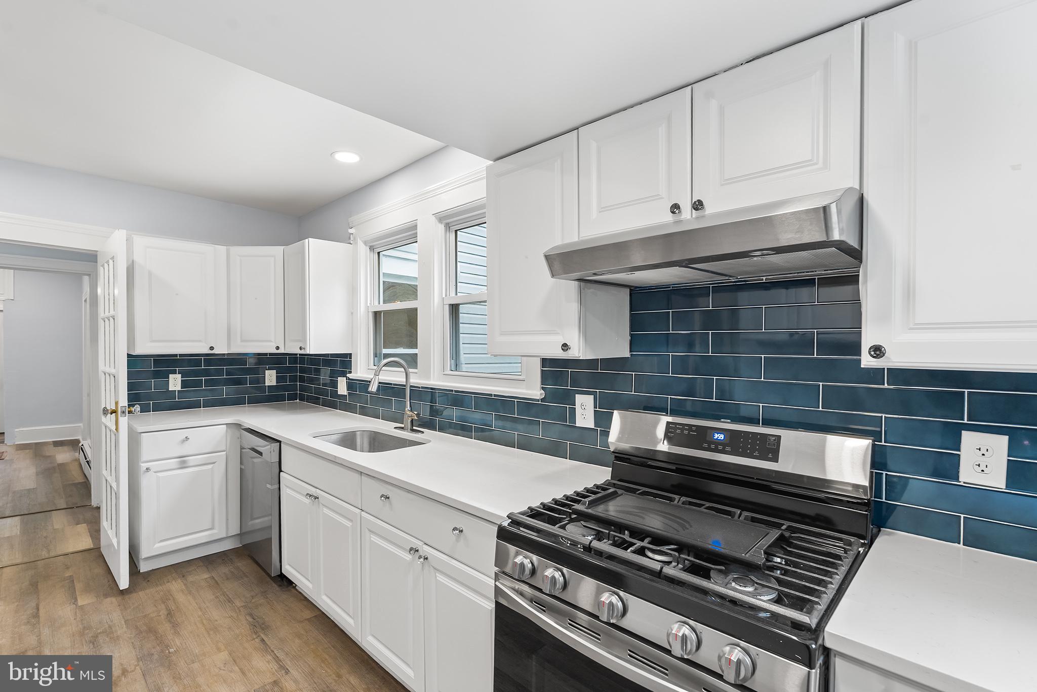 131 West Clinton Street Clayton, NJ 08312 - Photo 3 of 41 a kitchen with a stove and white cabinets