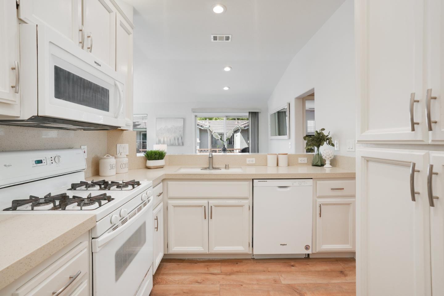 394 Oleander Drive San Jose, CA 95123 - Photo 7 of 27 a kitchen with white cabinets and appliances
