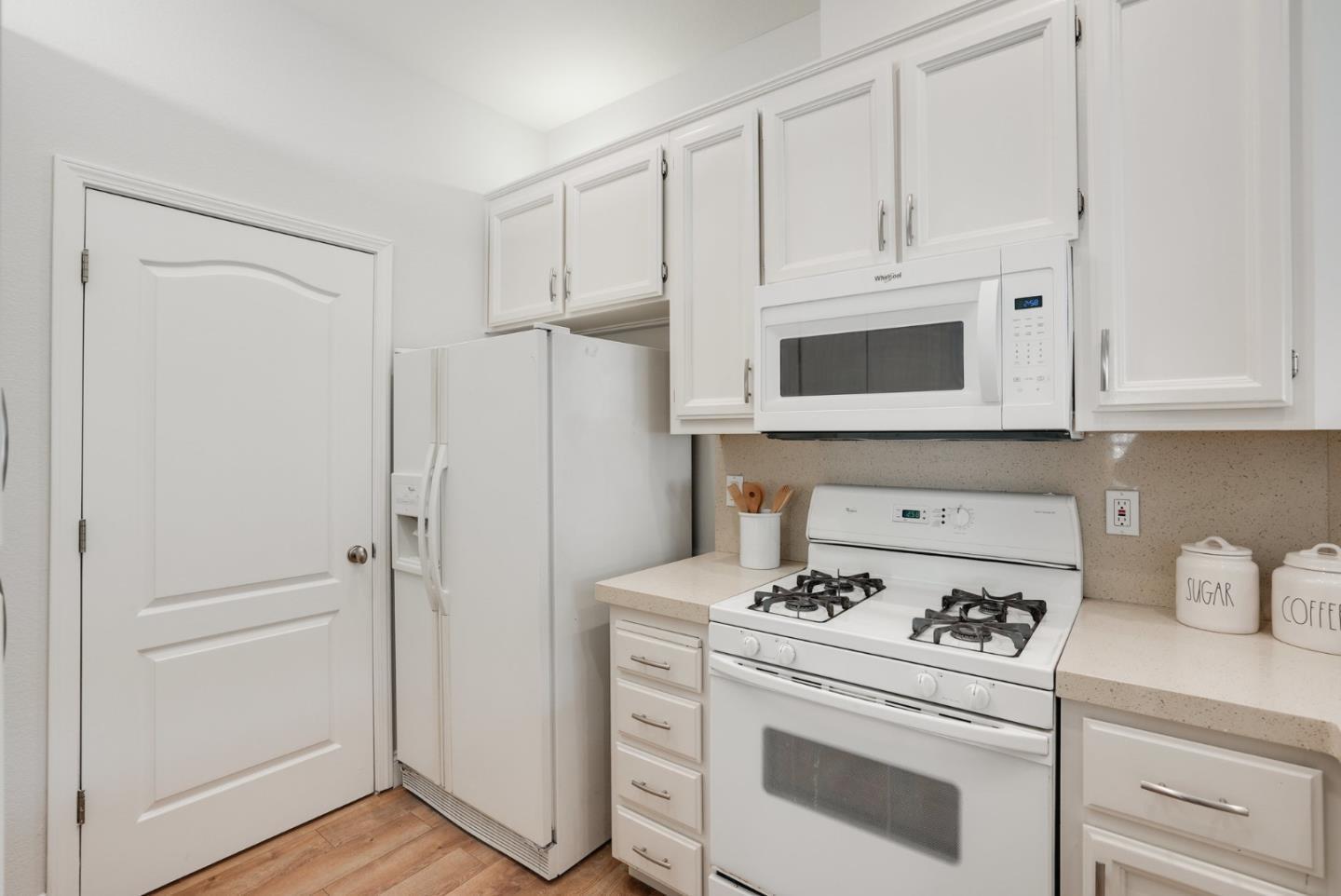 394 Oleander Drive San Jose, CA 95123 - Photo 8 of 27 a kitchen with white cabinets and white appliances