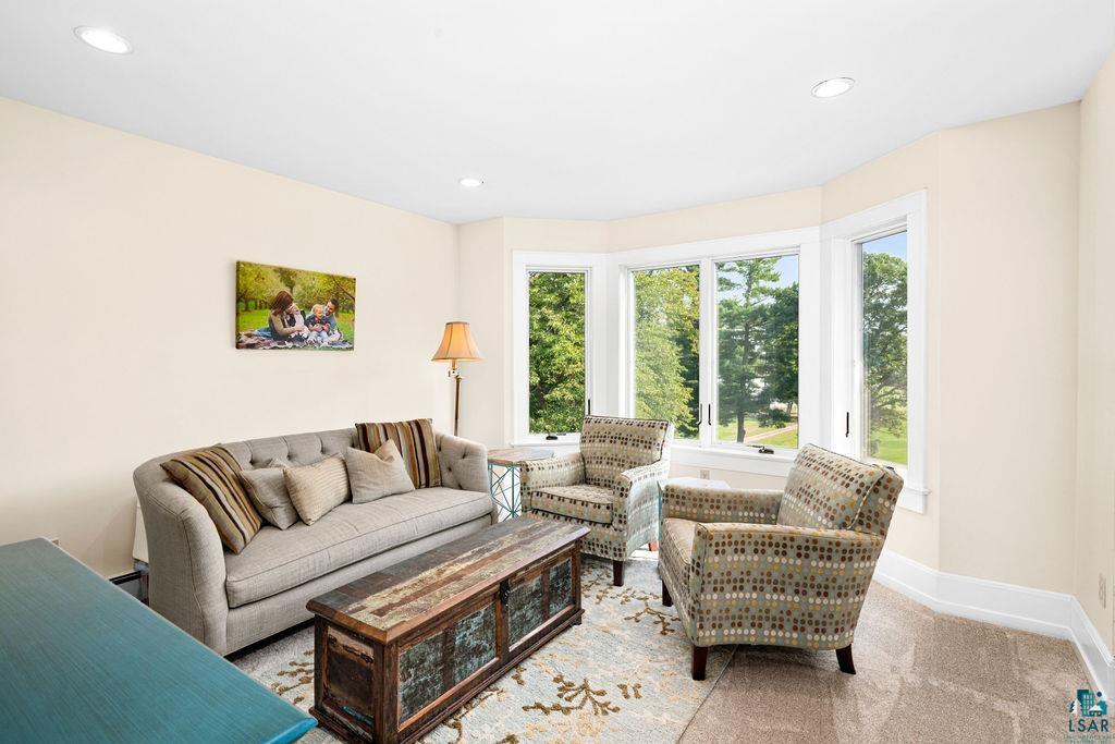 3168 Pioneer Road Barnum, MN 55707 - Photo 27 of 46 This loft area is a great little spot to hang out, read, watch a show and unwind. The bay windows provide beautiful views and natural light. Brand new, plush carpet throughout the upper level.