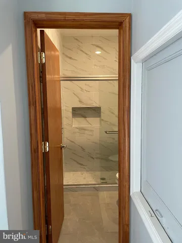 a bathroom with a glass shower door and mirror