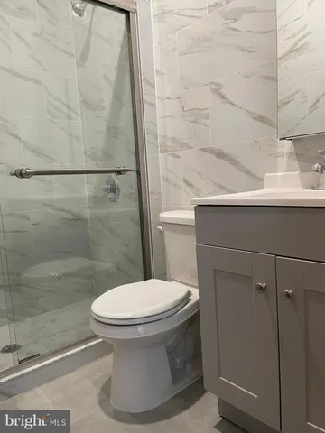 a bathroom with a toilet and a shower