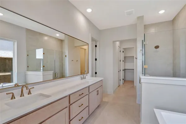 a spacious bathroom with a double vanity sink mirror double and shower