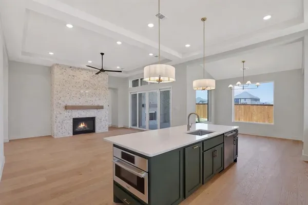 a kitchen with a chandelier chandelier and fireplace