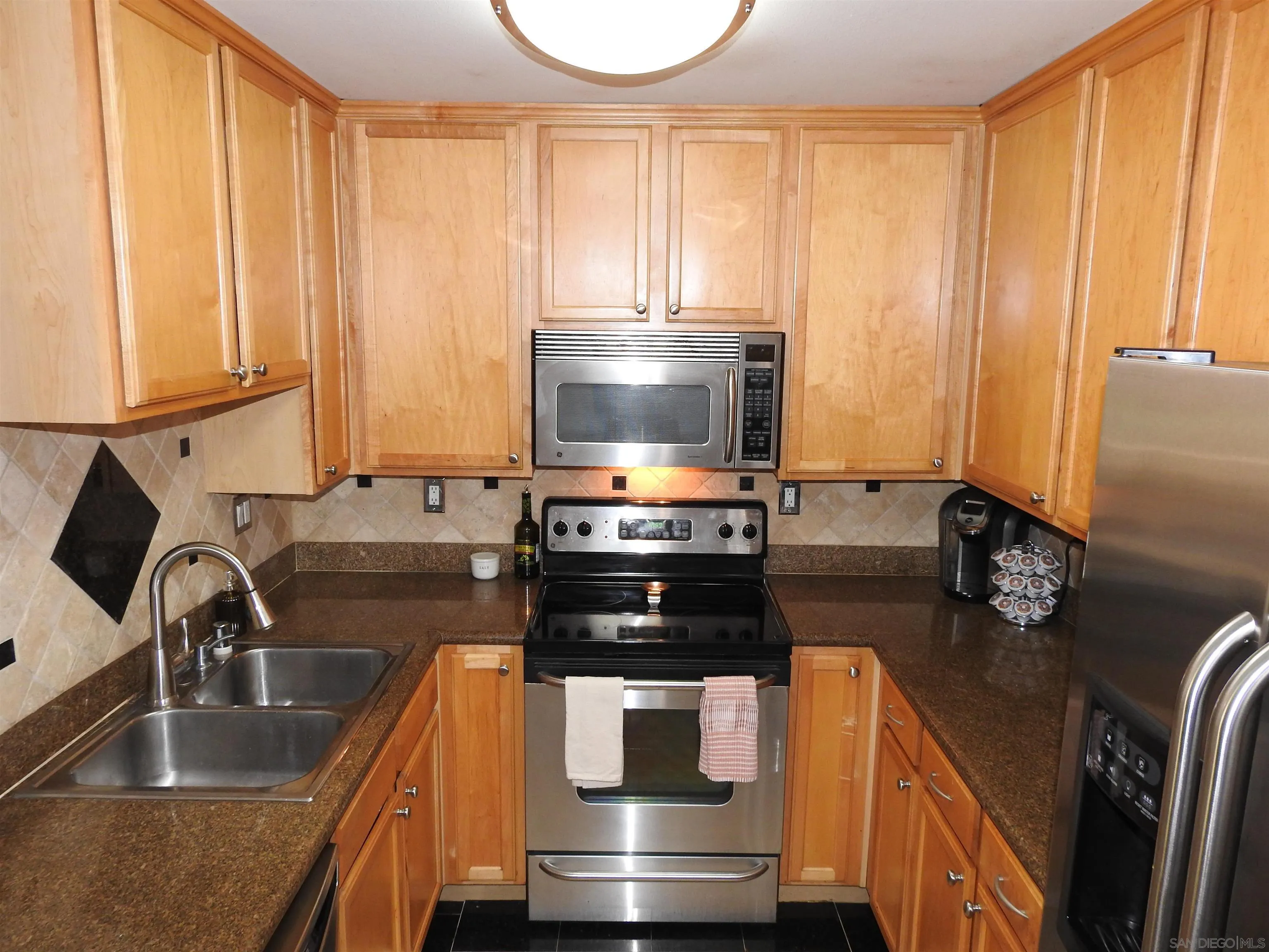 3515 Grove Street, Unit 108 Lemon Grove, CA 91945 - Photo 14 of 58 a kitchen with a stove and a sink