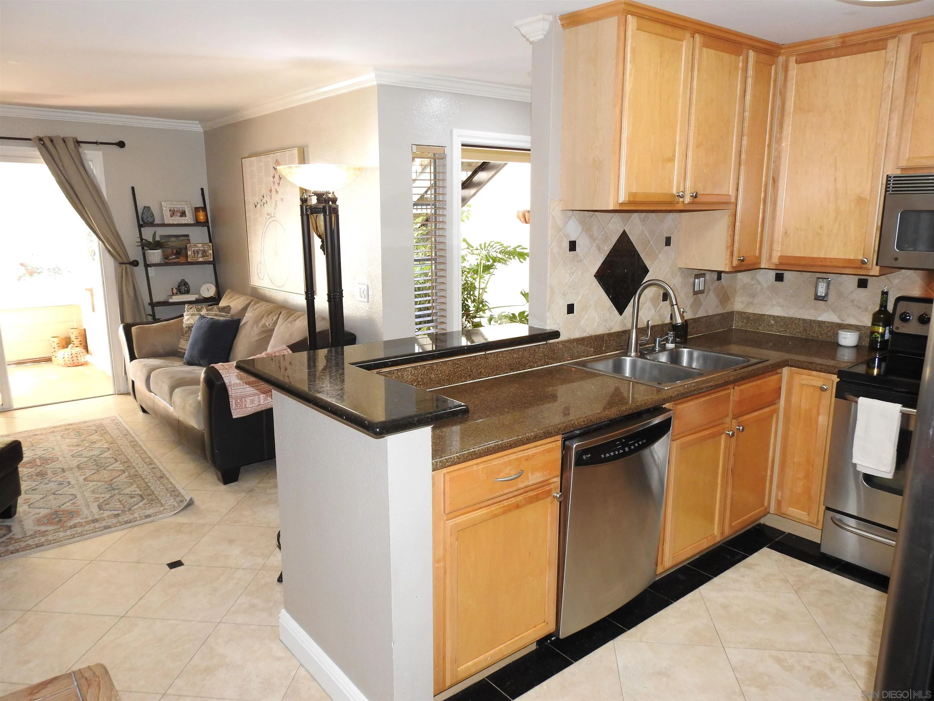 3515 Grove Street, Unit 108 Lemon Grove, CA 91945 - Photo 17 of 58 a kitchen with stainless steel appliances granite countertop a sink stove and cabinets