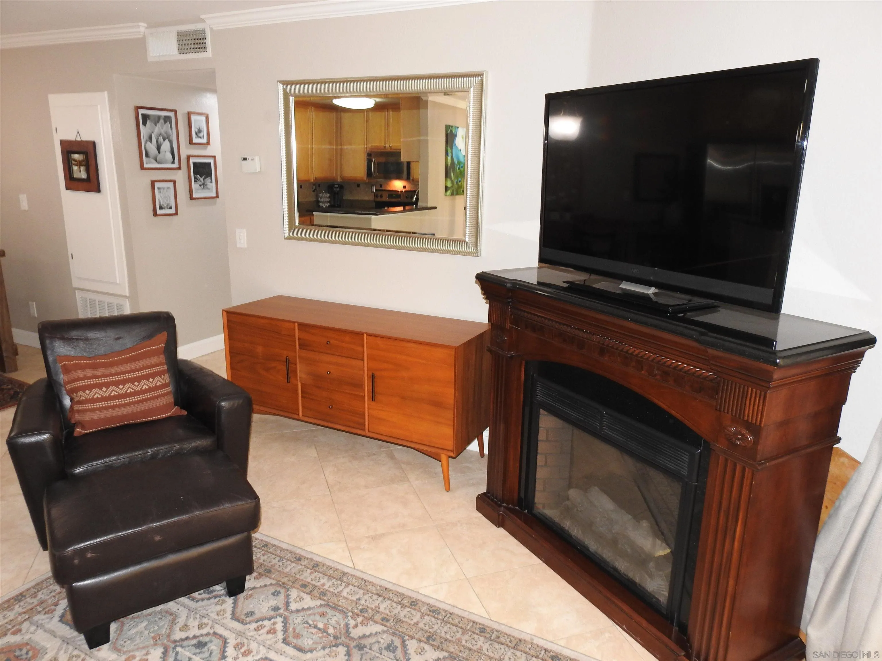 3515 Grove Street, Unit 108 Lemon Grove, CA 91945 - Photo 23 of 58 a living room with furniture and a flat screen tv