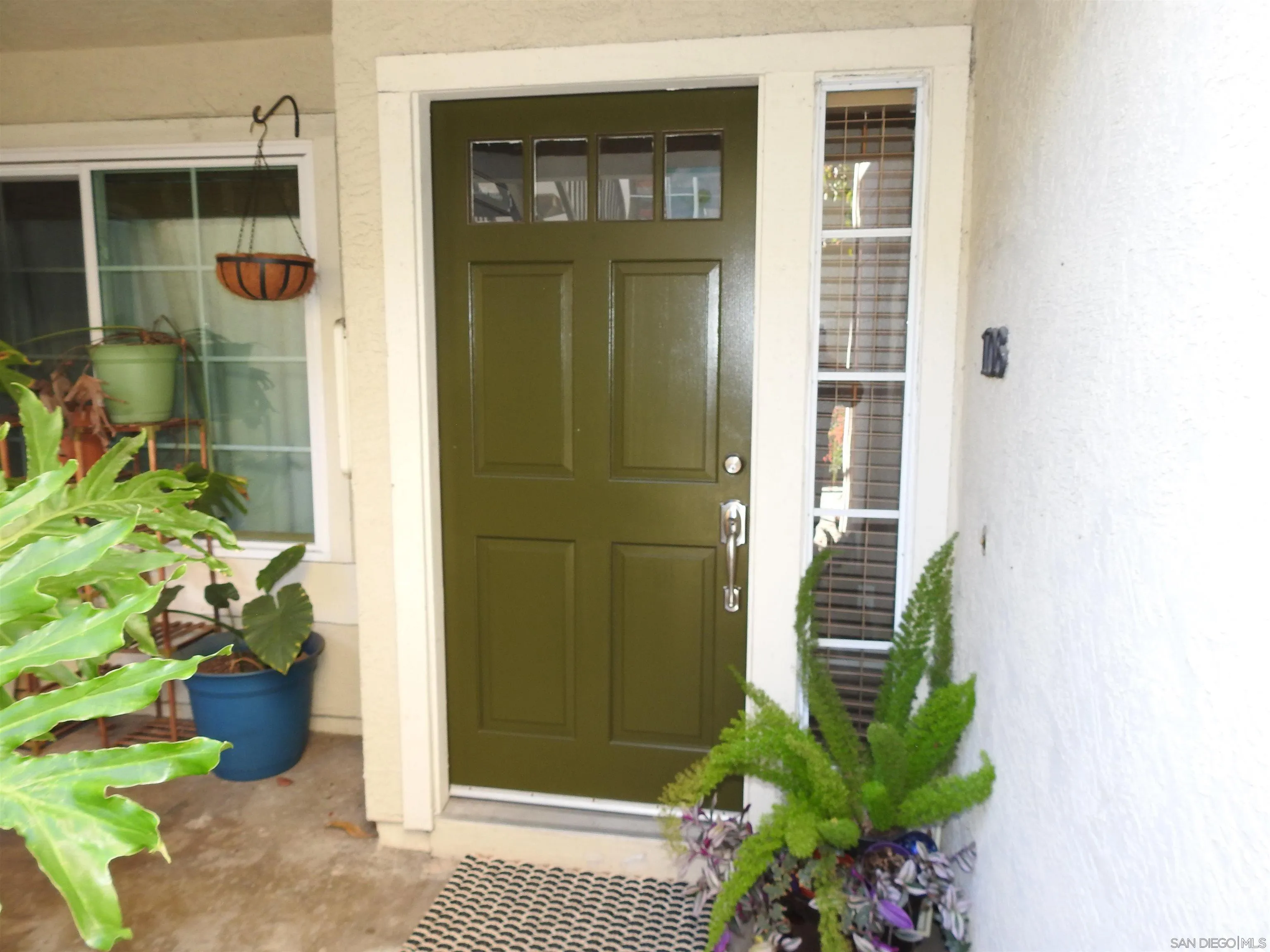 3515 Grove Street, Unit 108 Lemon Grove, CA 91945 - Photo 3 of 58 a potted plant sitting in front of a door