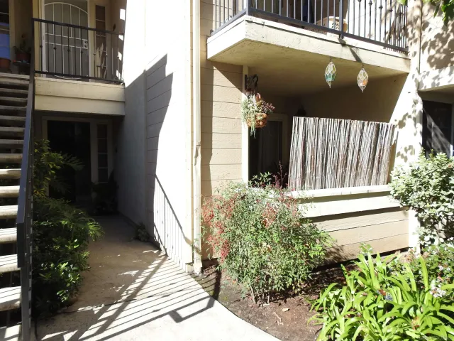 a backyard of a house with a table and chairs