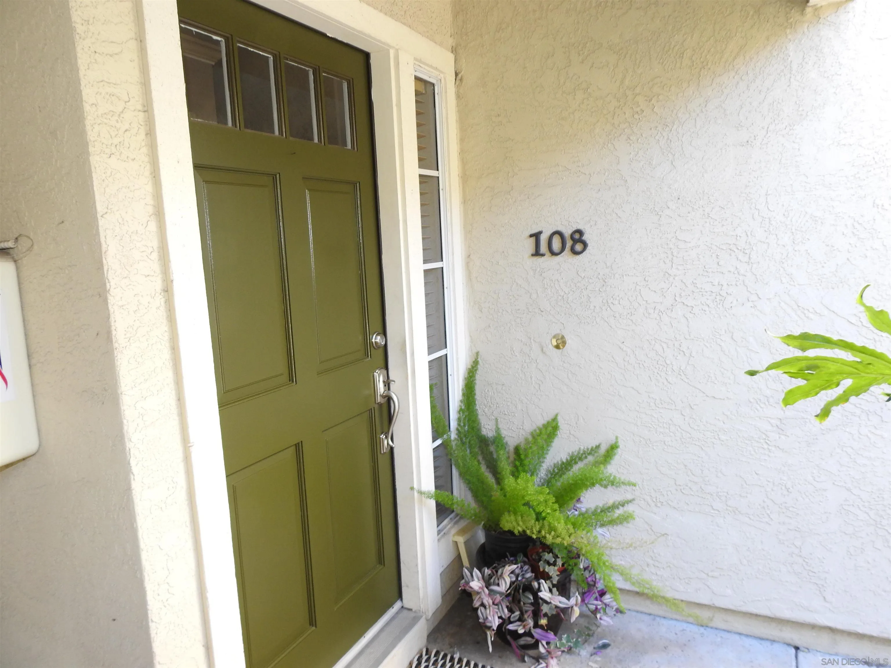 3515 Grove Street, Unit 108 Lemon Grove, CA 91945 - Photo 9 of 58 a white vase with white and yellow flowers
