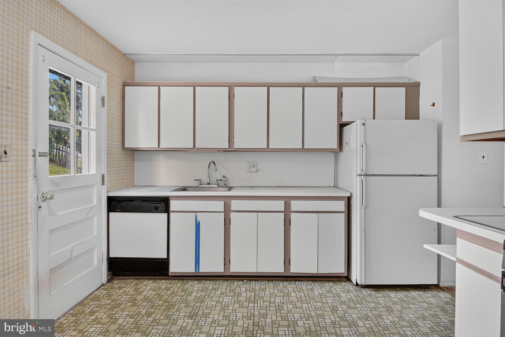1326 Gresham Road Silver Spring, MD 20904 - Photo 15 of 30 a kitchen with stainless steel appliances granite countertop a refrigerator sink and white cabinets