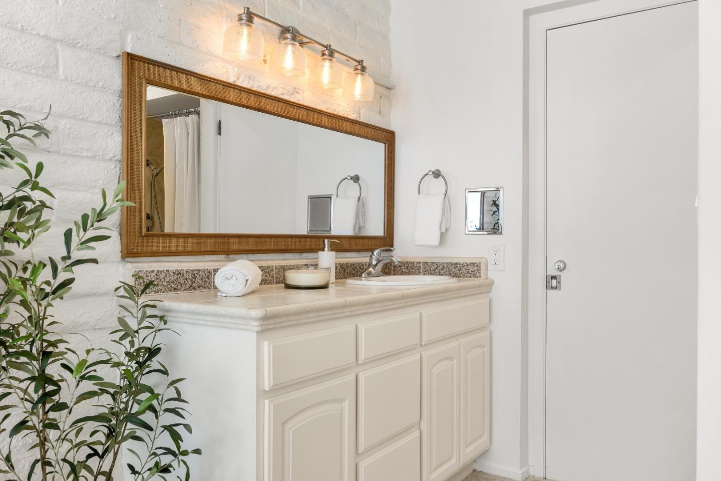 230 Rio Del Mar Boulevard, Unit K Aptos, CA 95003 - Photo 16 of 29 a bathroom with a granite countertop sink and a mirror