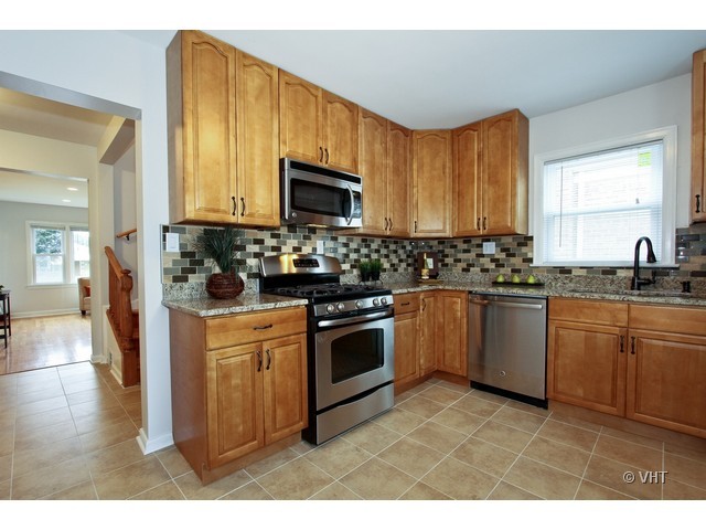 2250 Northgate Avenue North Riverside, IL 60546 - Photo 3 of 17 a kitchen with stainless steel appliances granite countertop a stove a sink dishwasher and a microwave oven with cabinets