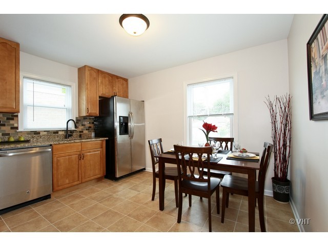 2250 Northgate Avenue North Riverside, IL 60546 - Photo 4 of 17 a kitchen with a dining table chairs and refrigerator