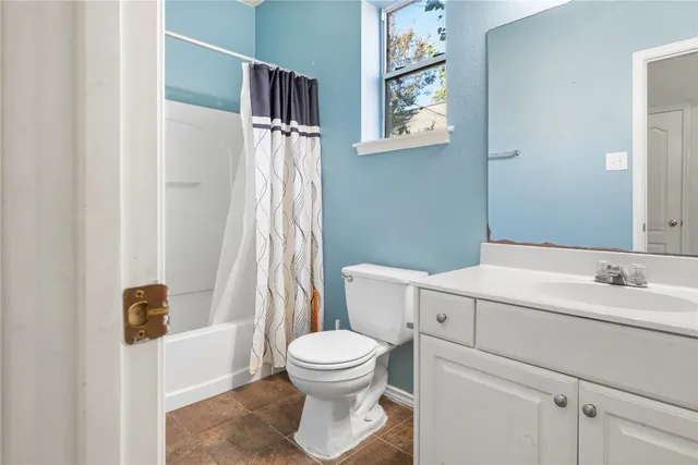 a bathroom with a toilet sink and shower