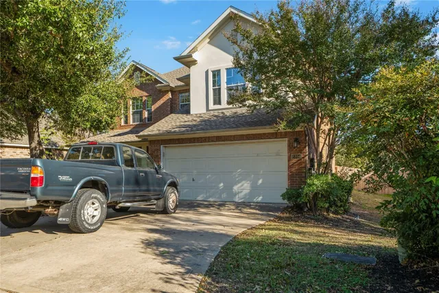a front view of a house with a parking space